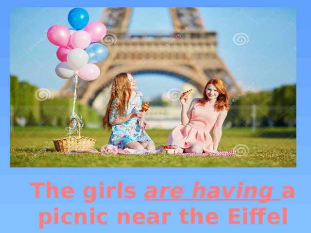 The girls are having a picnic near the Eiffel Tower. 