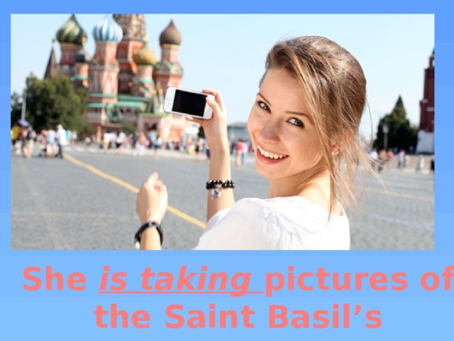 She is taking pictures of the Saint Basil’s Cathedral.