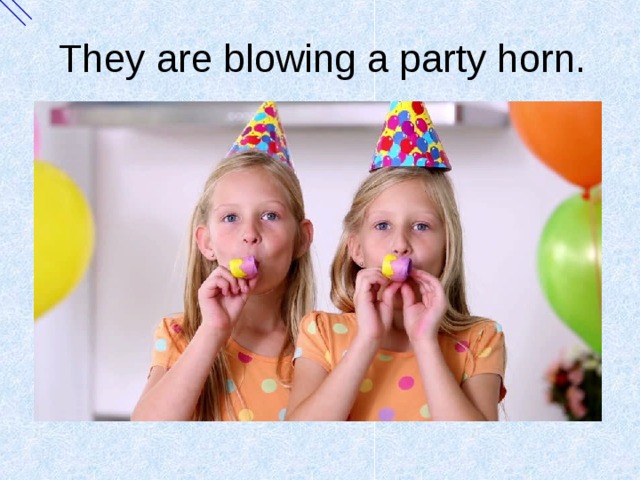 They are blowing a party horn. 