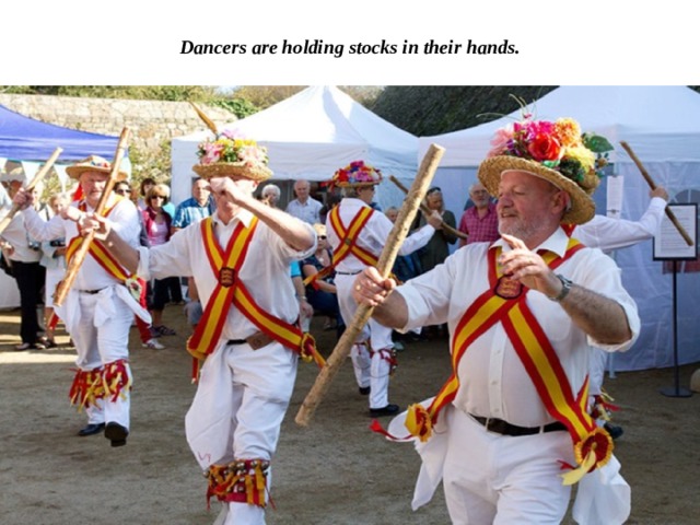 Dancers are holding stocks in their hands. 