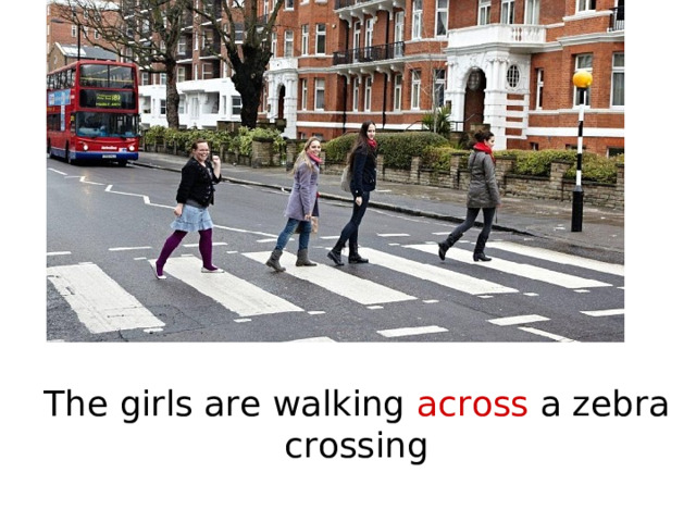The girls are walking across a zebra crossing 
