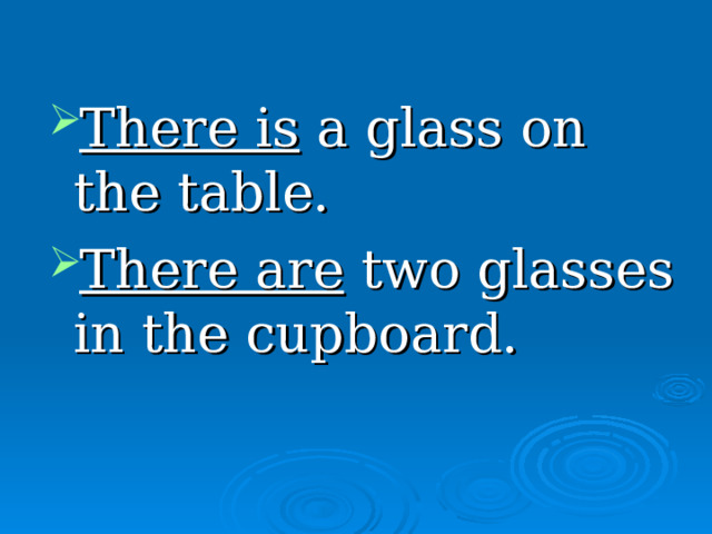 There is a glass on the table. There are two glasses in the cupboard. 
