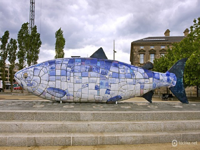 The Big Fish One of the most popular attractions is the 10 – metres figure of “the Big Fish”. The Big Fish  also called the  Bigfist  is a printed ceramic mosaic sculpture  by John Kindness.  It was  constructed in 1999. 